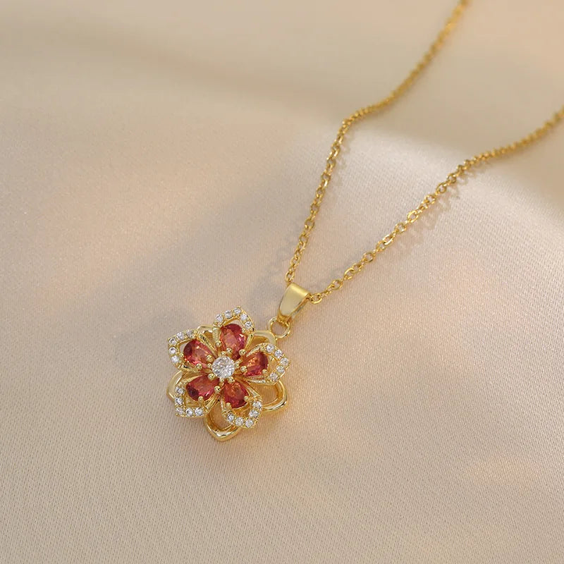 Vibe Atelier Eternal Bloom Rotatable Flower Necklace, gold-plated with red and clear zirconia, front view.