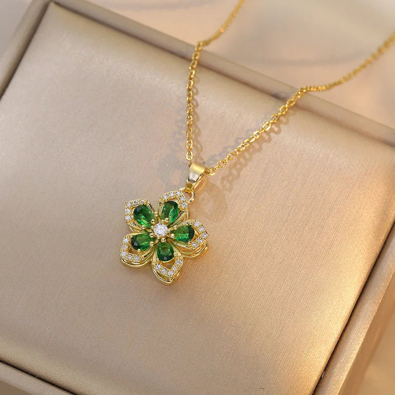 Vibe Atelier Eternal Bloom Rotatable Flower Necklace, gold-plated with green and clear zirconia, front view.