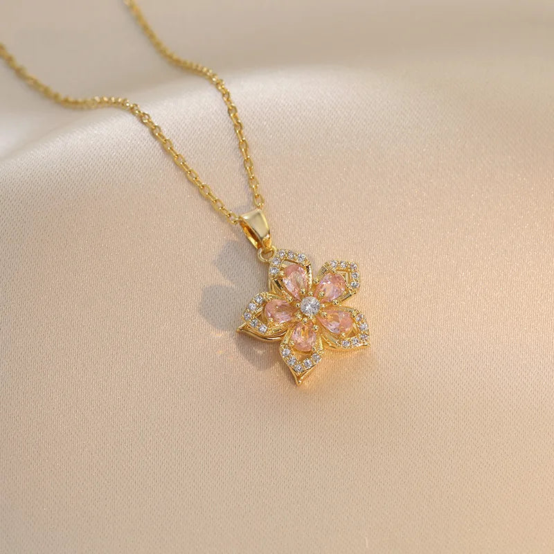 Vibe Atelier Eternal Bloom Rotatable Flower Necklace, gold-plated, with pink and clear zirconia stones, front view.