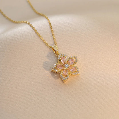 Vibe Atelier Eternal Bloom Rotatable Flower Necklace, gold-plated, with pink and clear zirconia stones, front view.
